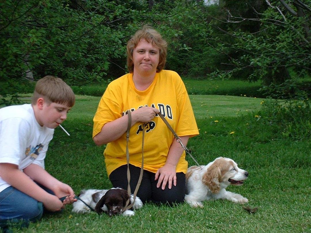 betsy and andrew with the dogs in the front yard