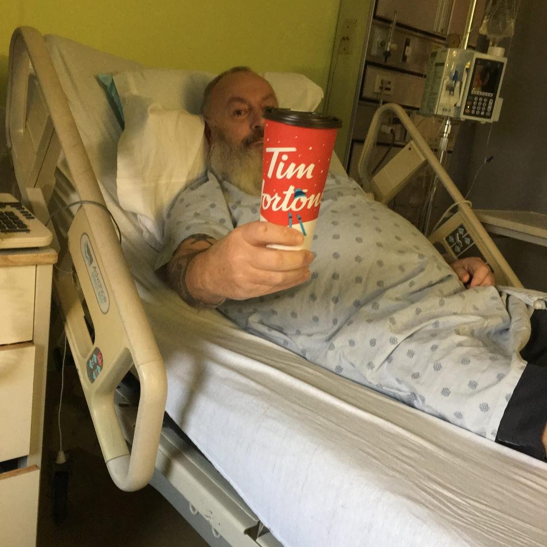 Me in hospital after stroke. enjoying my Tim's and looking alert.