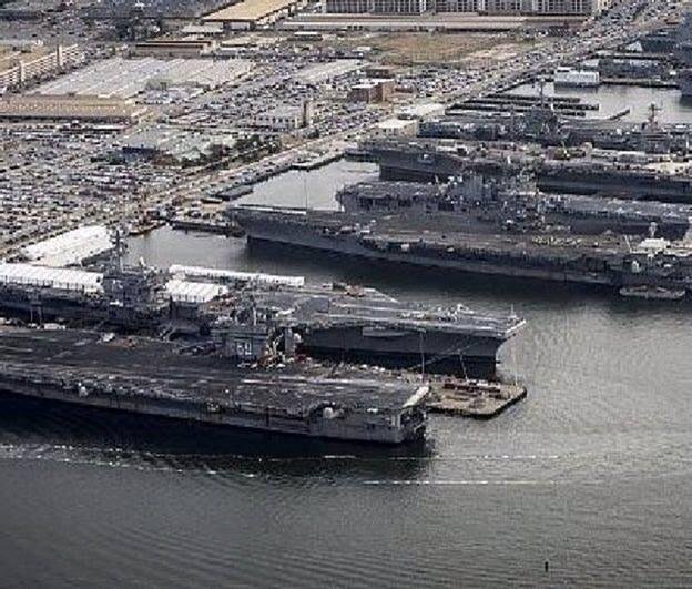 Looks like the "before" at Pearl Harbor.  Nope,  It's Norfolk.  It seems they would learn a lesson about having them all lined up in one place.