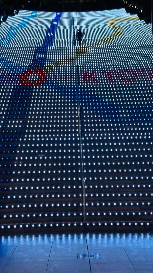 This is an 8-story stairway in the Kyoto train station. Lights on the edges of each stair layer are synchronized to project moving images for the observer standing at the bottom. A dazzling spectacle indeed - and this is ju