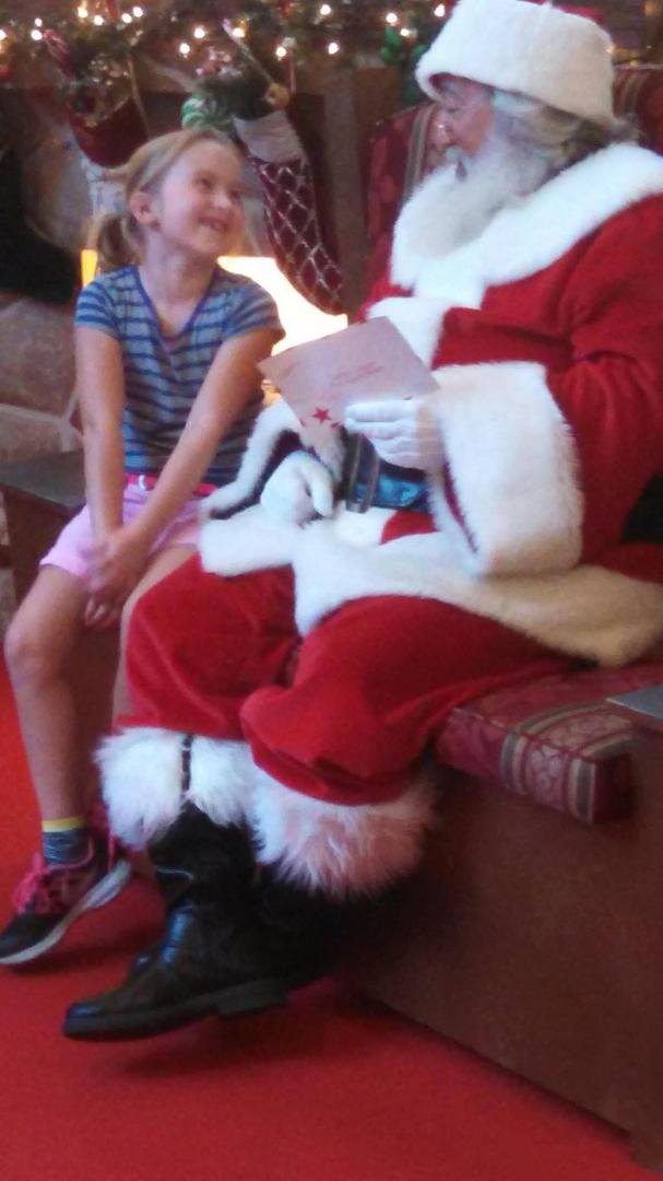 A True Believer! My grandniece Abby with Santa. Love the faith!