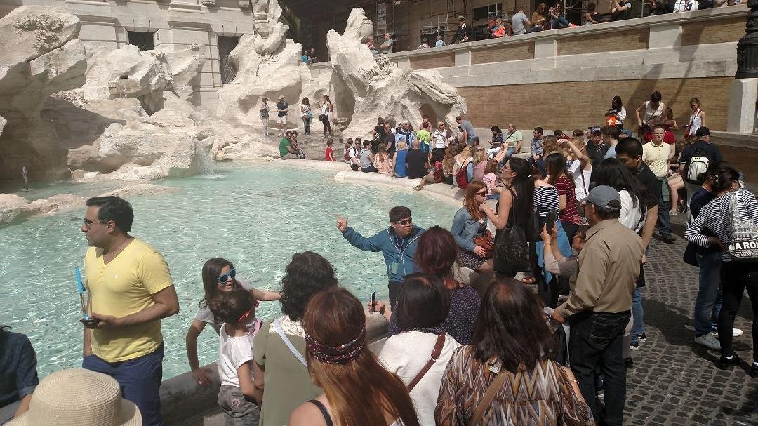 Fr. Edwin casting a coin into the Trevi Fountain.