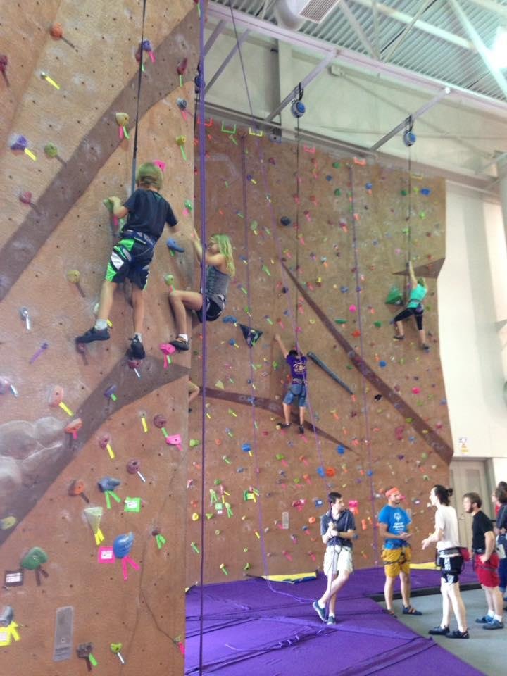 Sophia and andrew climbing the wall