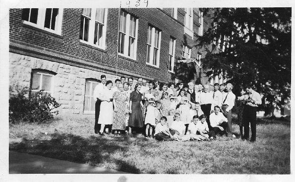 Group picture taken in fron of the school.