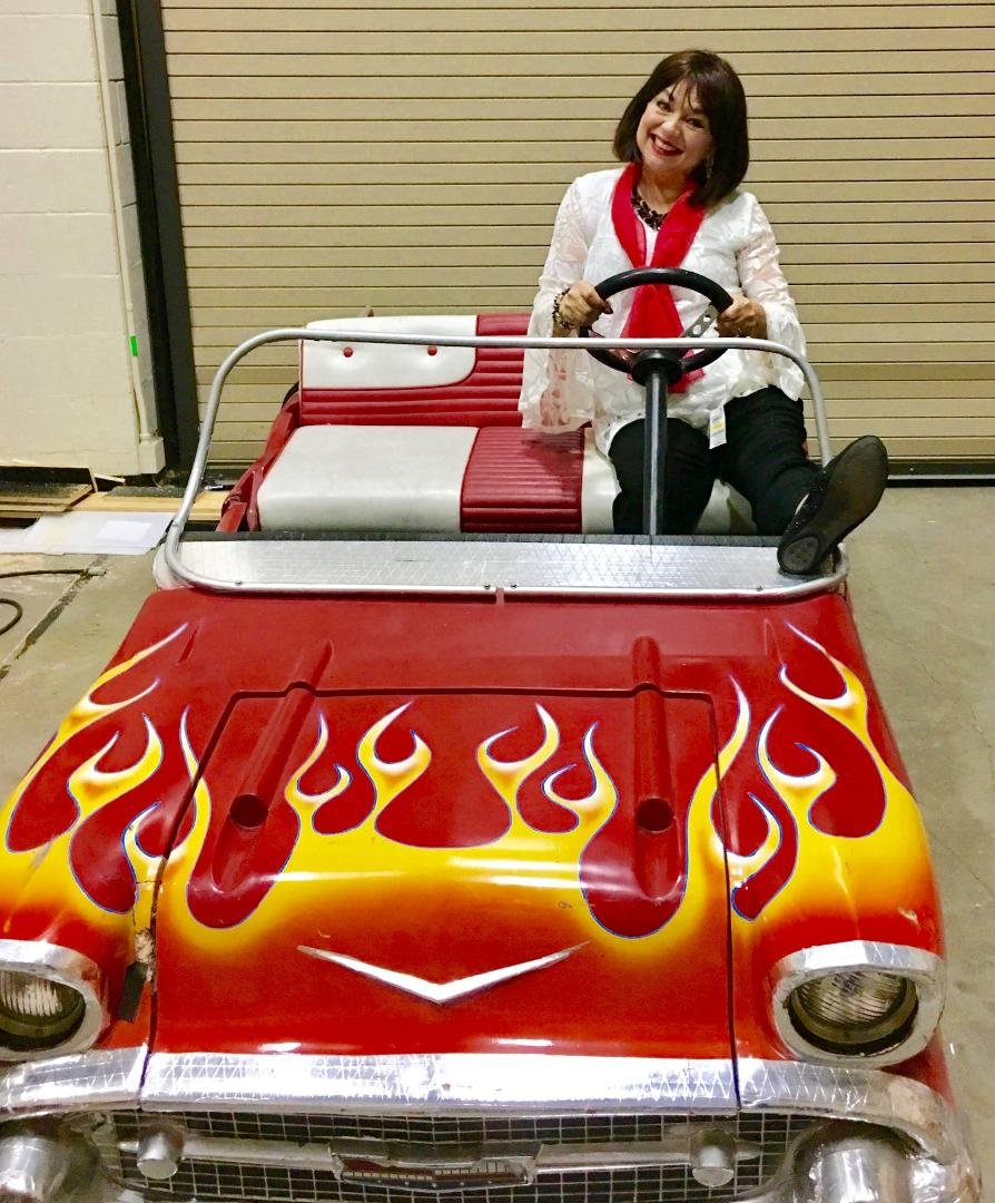 I am hiding here backstage in The Beach Boys cool car that dancer Karen Brandt drives around in Beach Boys Medley while I dance with a walker playing an old lady!