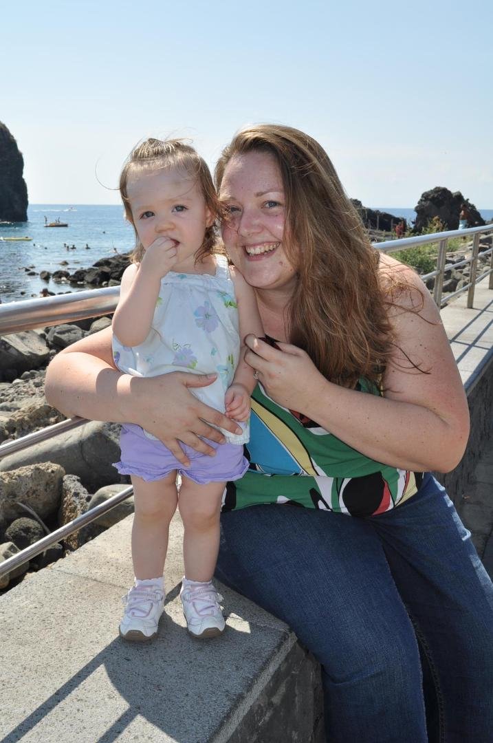 Dorothy and Leah in Acitrezza with I Faraglioni in the background.