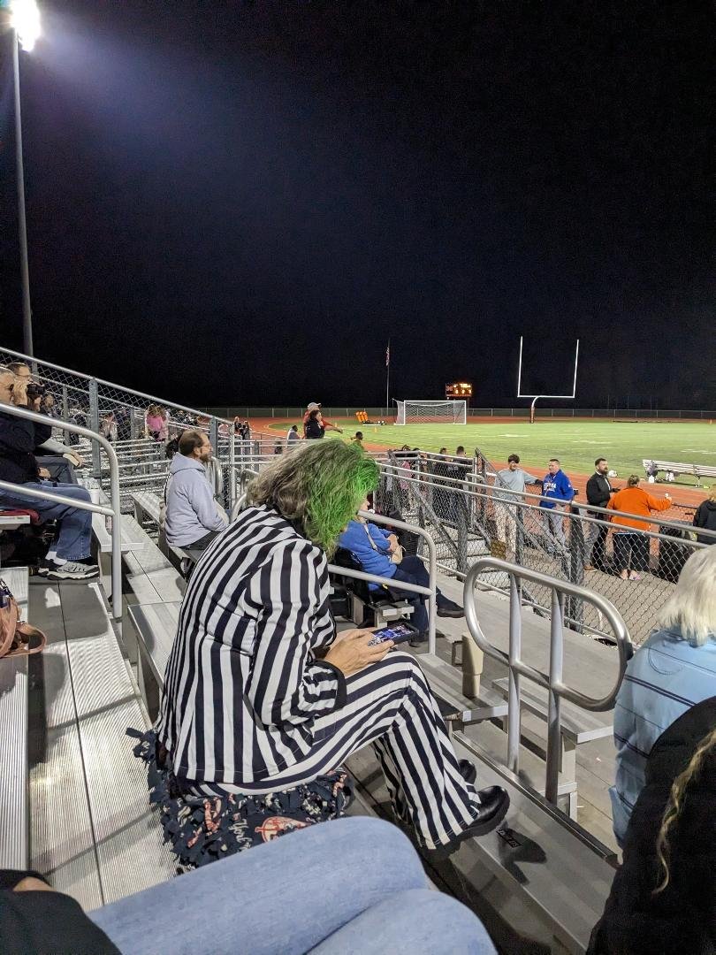 Beetlejuice at the Montville High School homecoming game checking his email.