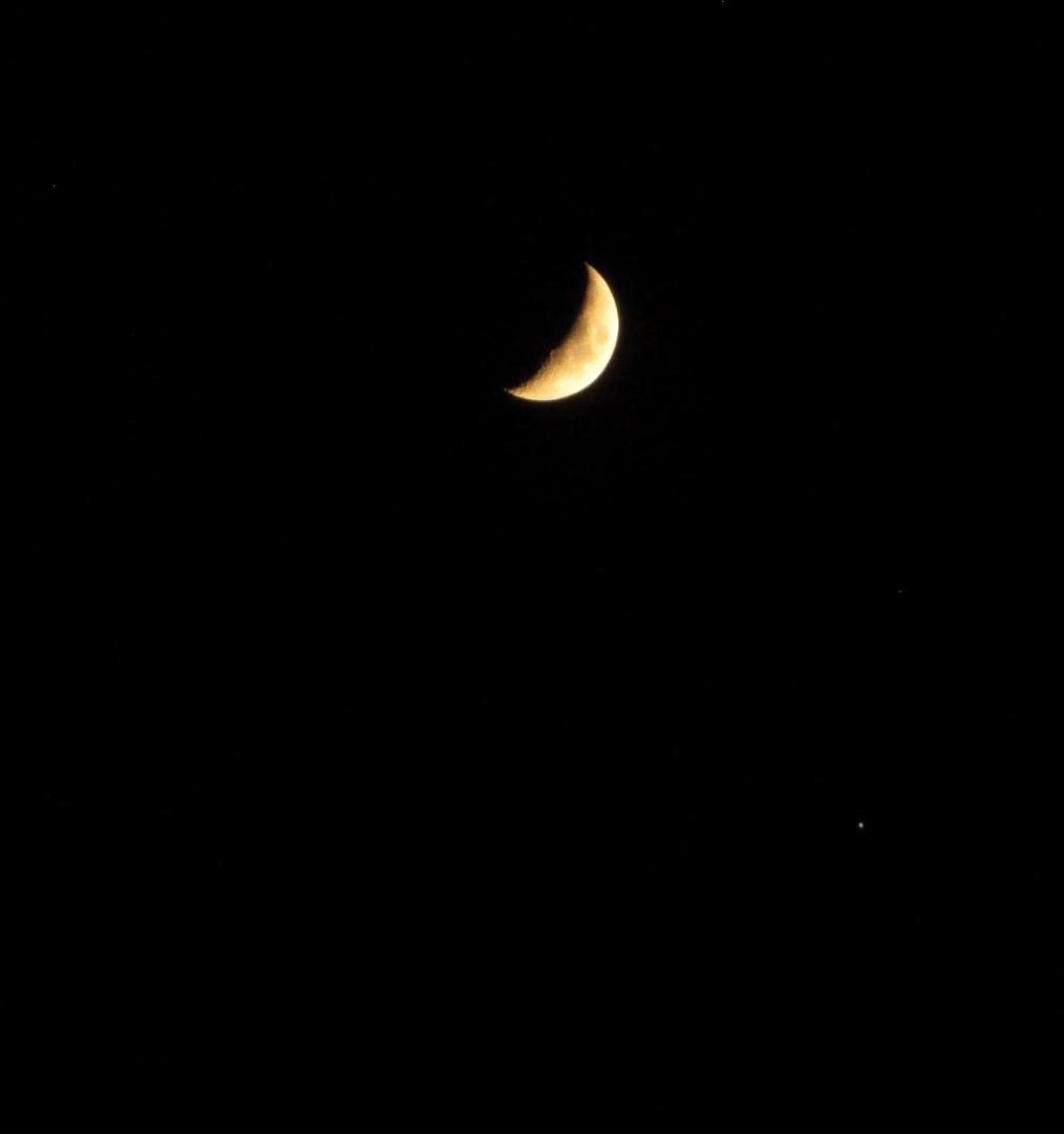 The planet Jupiter (can you see it?) below the crescent moon on 10/3/19.  Tomorrow night the moon will be in proximity to Saturn.