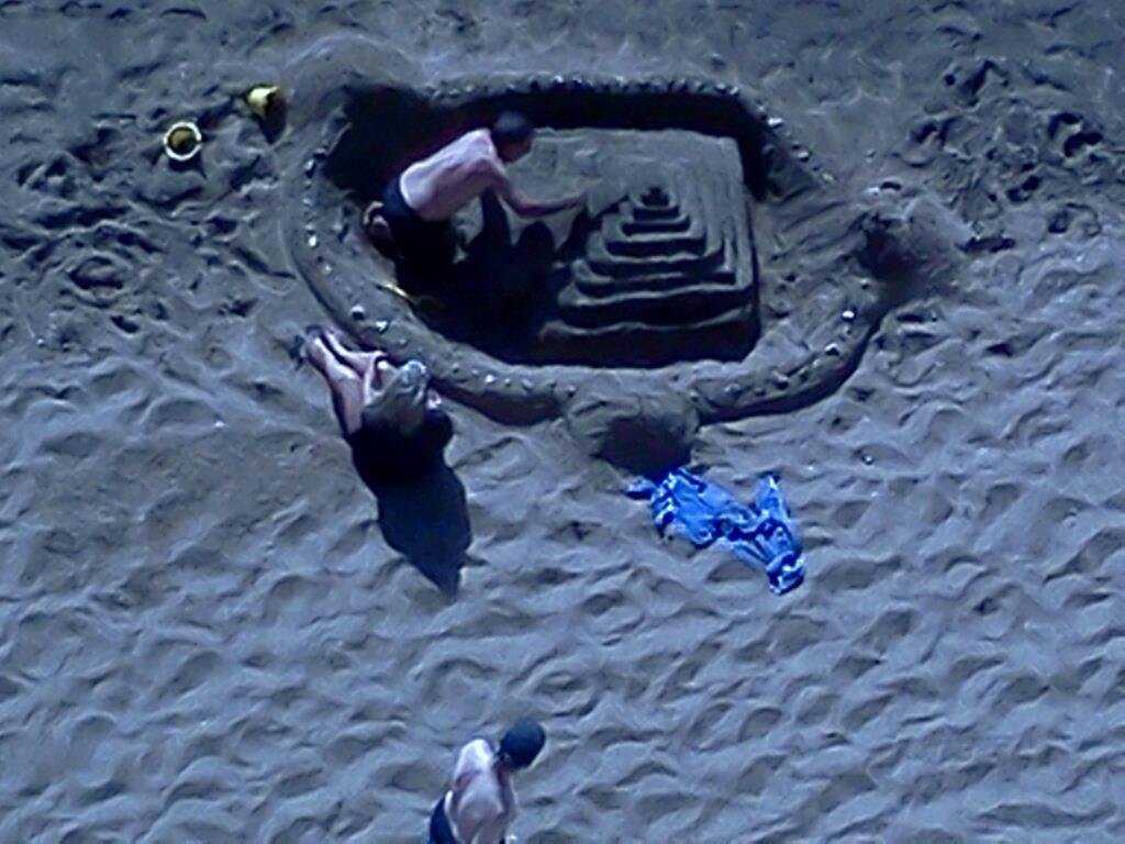 On the beach in Maui. Look at this guy's cool sandcastle. Shot photo from our balcony of apartment at Kahana Beach Resort. Got in last night.