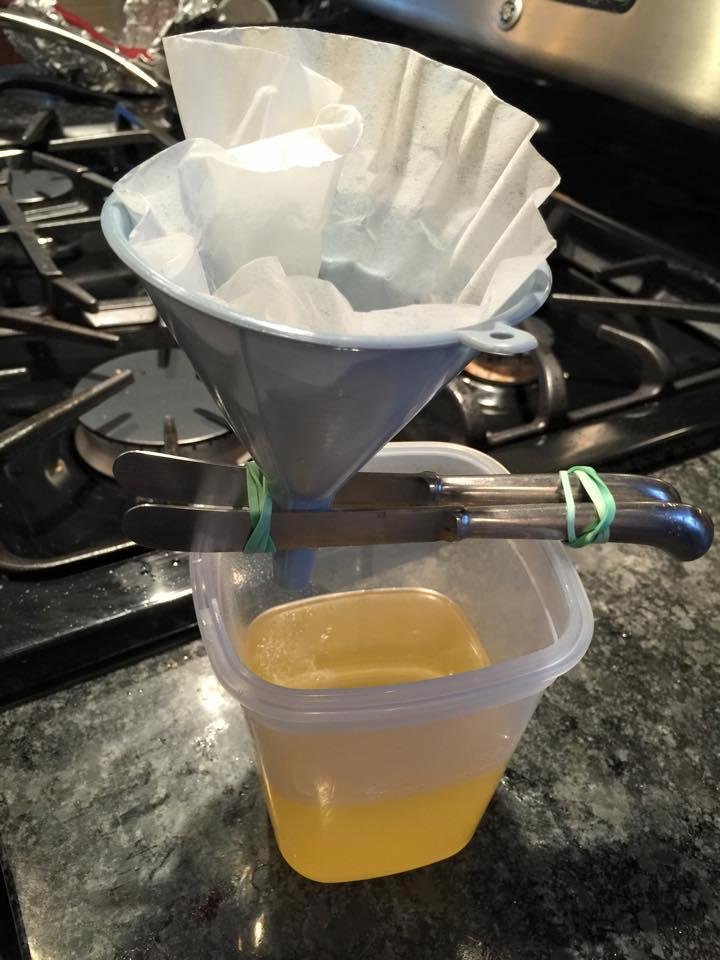 Sometimes one has to improvise. My Rube Goldberg device to raise the funnel over the container to facilitate filtering the impurities out of rendered goose fat. Notice the beautiful consistency of the filtered fat. Goose