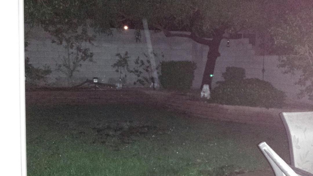 I took this pic last nite of a corner in my back yard. I was trying to show how the shrub lights weren't working. The diagonal beam of light is shining down on a white decorative angel. When I took the pic there was no beam