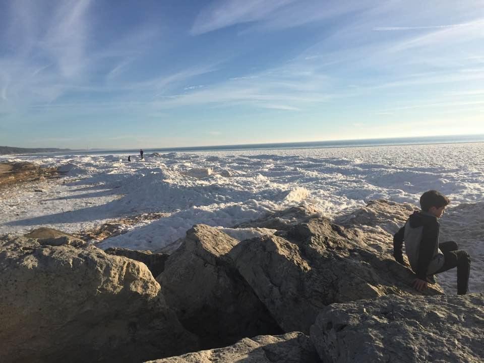 Donna's happy place. Grand Haven standing on the ice of Lake Michigan. 57 degrees.
