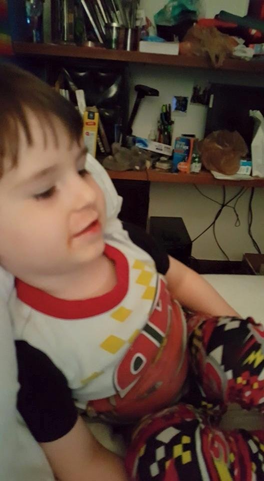 Austin lounging in my bed watching "Earth to Echo' last night.