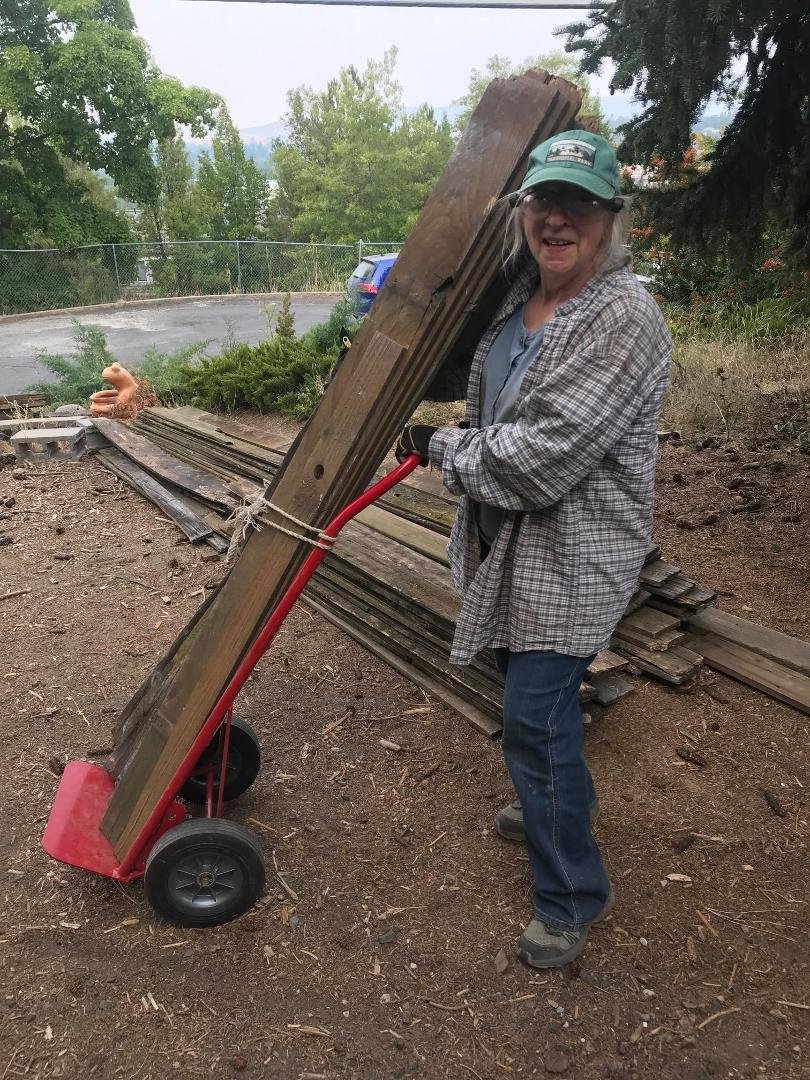 My wife hauling yet another load of fence boards up to the driveway. We have been able to pull all the nails and bring 2/3's of the stuff up to the drive way. We are in the home stretch!