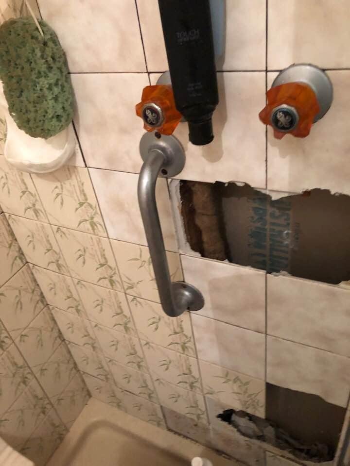 Tiles taken off wall to block pipe to stop leak.