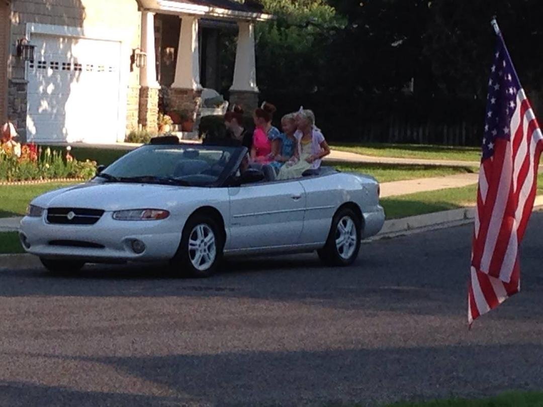 Boyd driving neighborhood girls in the neighborhood "Days 47" Parade.