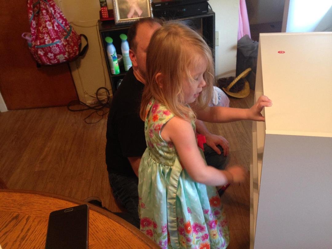 Sophia Sabine Larson-Fatzer helping dad build a shelf for grandma.