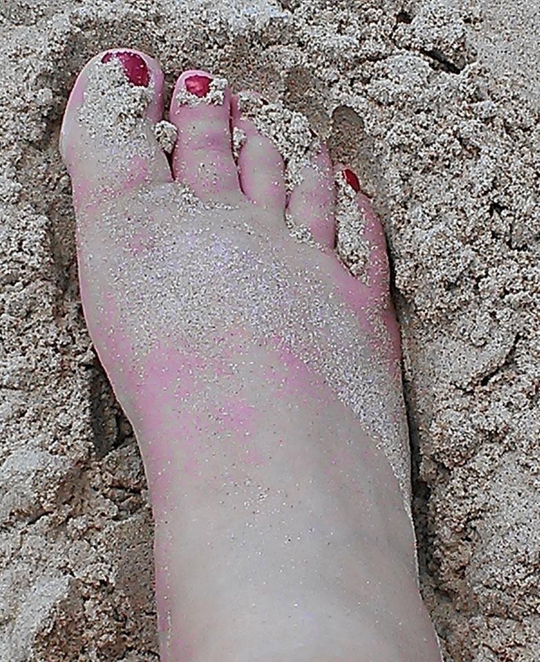 Toes in the sand and cold drink in hand..