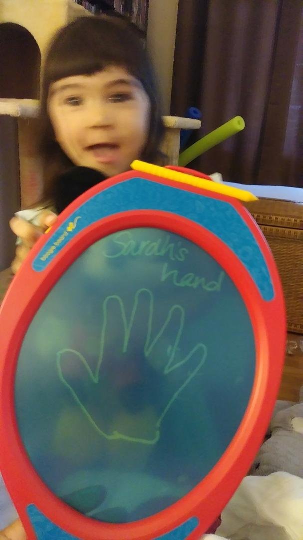 Having fun doodling.
Sorry for the blurriness. She was about erase the artwork while I was taking the picture. (The erase button is under her forefinger.) She wanted me to draw Mickey Mouse. 😂