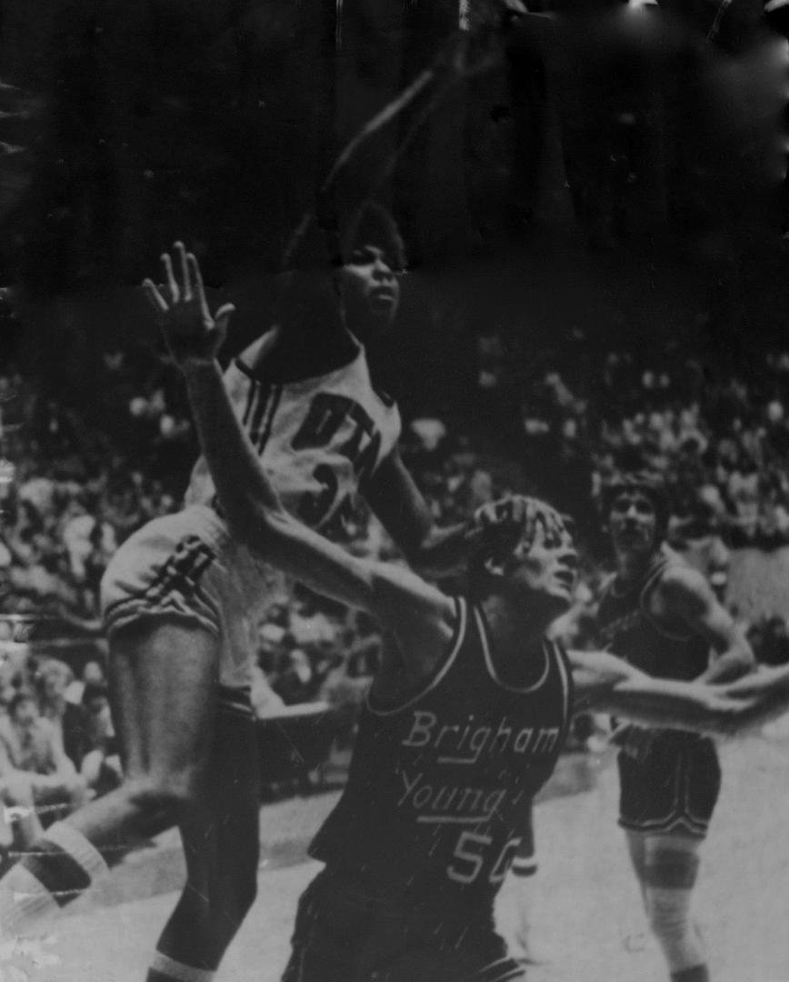 Buster Matheney soars against the Y. Note Gifford Nielsen in background.