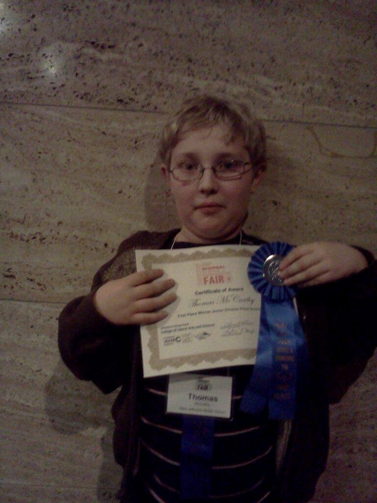 Grandson thomas at DMNS with his first place award in science fair plant sciences division. He now goes to compete in state at CSU in April.