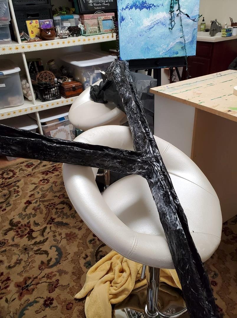 Black issue paper and Elmer's glue, diluted. Because of its shape it wants to slide all over. Put towels down and it turns and tears the paper. Done for today. Patch work tomorrow.