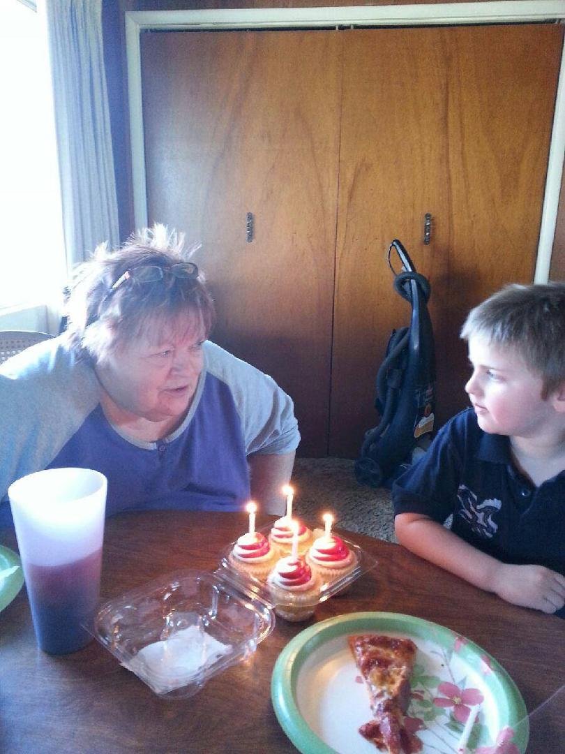 Conner and gmom counting to blow out the candles, gmom forgot to do her hair but at least I was dressed. Lol