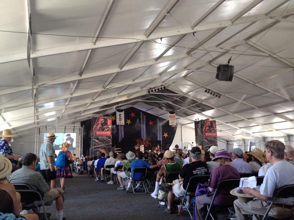 Margaret and I are sitting in the Jazz Tent at the New Orleans Jazz and Heritage Festival, listening to the James Rivers Movement
