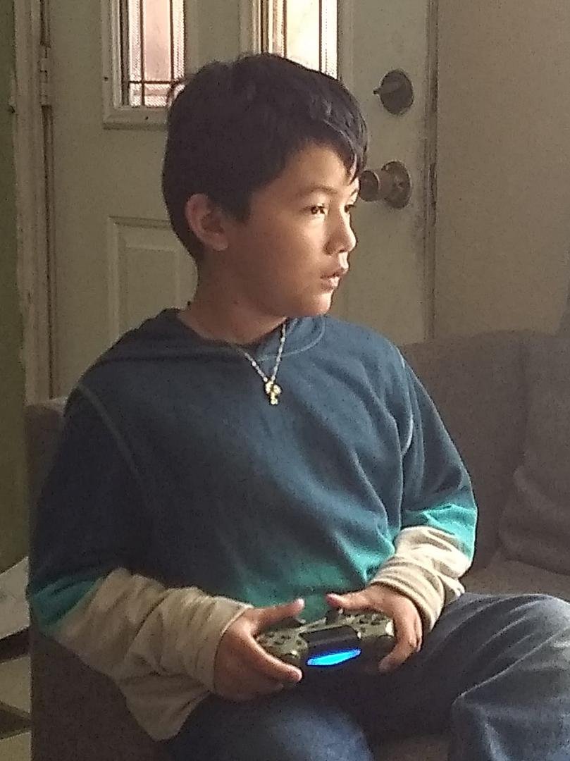 My Grandson Jayden at 8.8 years playing his favorite game MINDCRAFT on his PlayStation