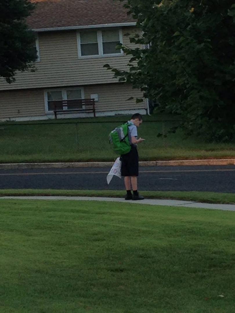 Waiting for the bus.  He said,  "Ok, Mom you can go, I don't need you anymore!!"  WTH