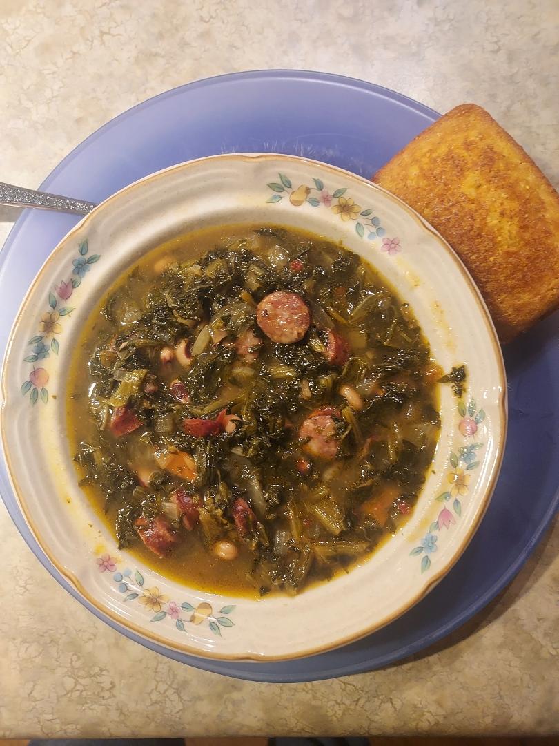 Traditional New Years Day Swamp Soup with turnip greens, black-eyed peas, and yes Steve Garrett, conecuh sausage. Also, cornbread on the side.