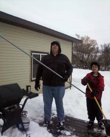 Big John and Little Jon watching Pepe James shovel the roof!