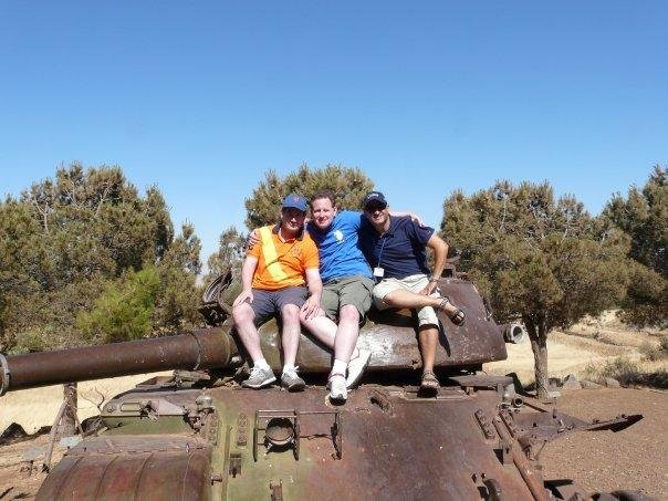 Gregg, David and our tour guide on a destroyed Syrian tank.