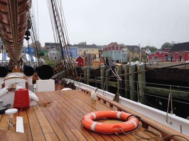 on the tall ship with colorful homes in background