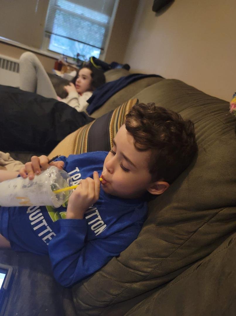 One kiddo finishing his vanilla shake, the other watching Mets game with me