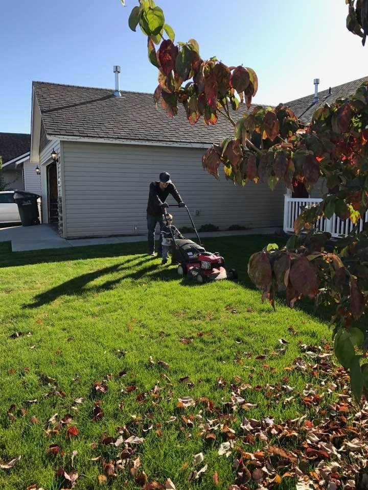 My neighbor and his two year old mowing their lawn and part of mine!❤️