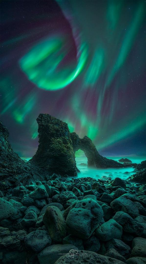 Spiral Aurora over Iceland
Image Credit & Copyright: Stefano Pellegrini
Explanation: The scene may look like a fantasy, but it's really Iceland. The rock arch is named Gatklettur and located on the island's northwest coast
