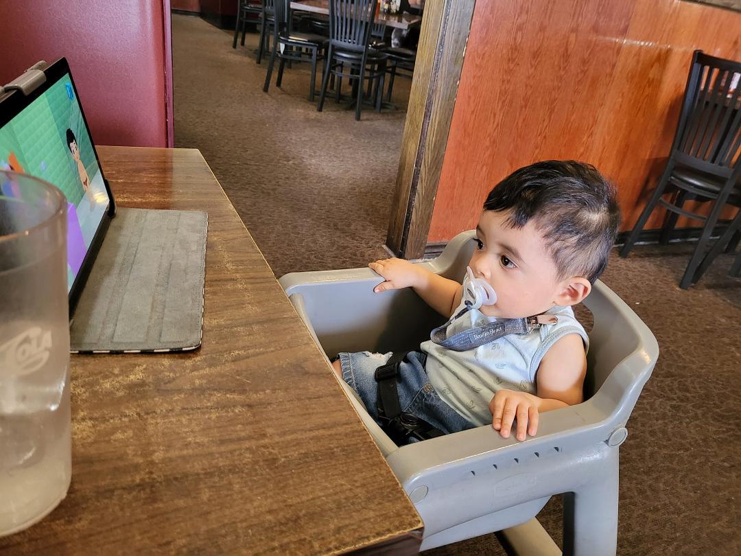 Also his first time sitting in a high chair