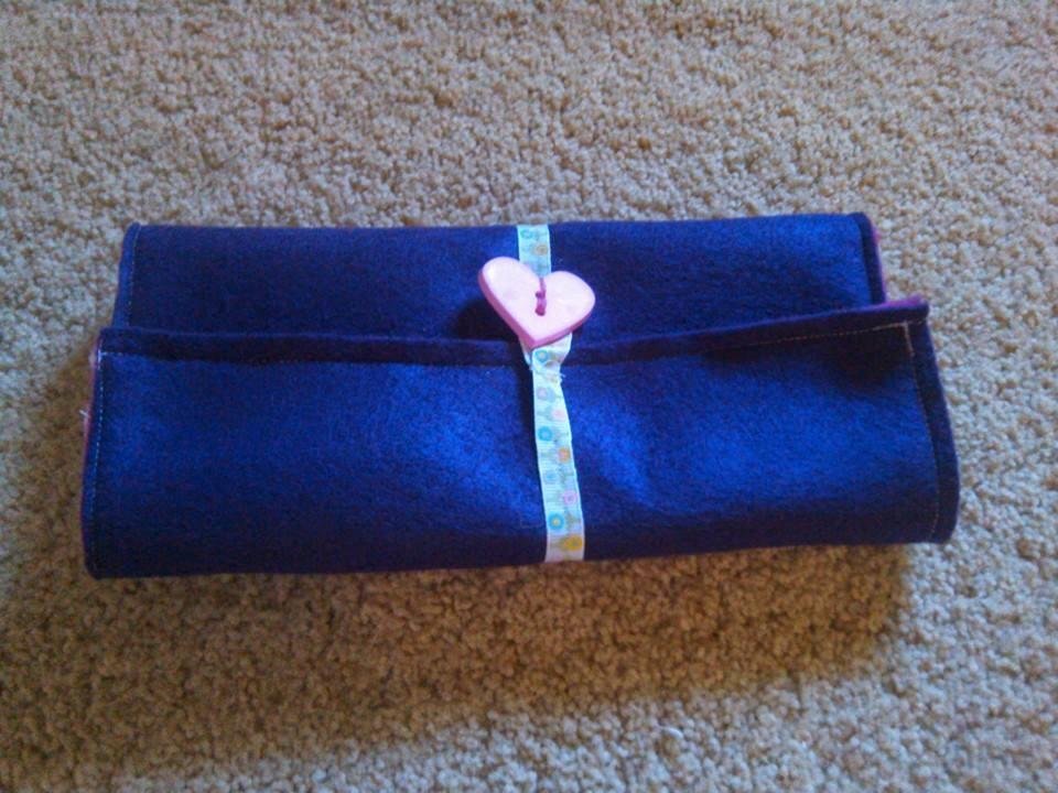 pencil case folded together with the pencils and pad inside
