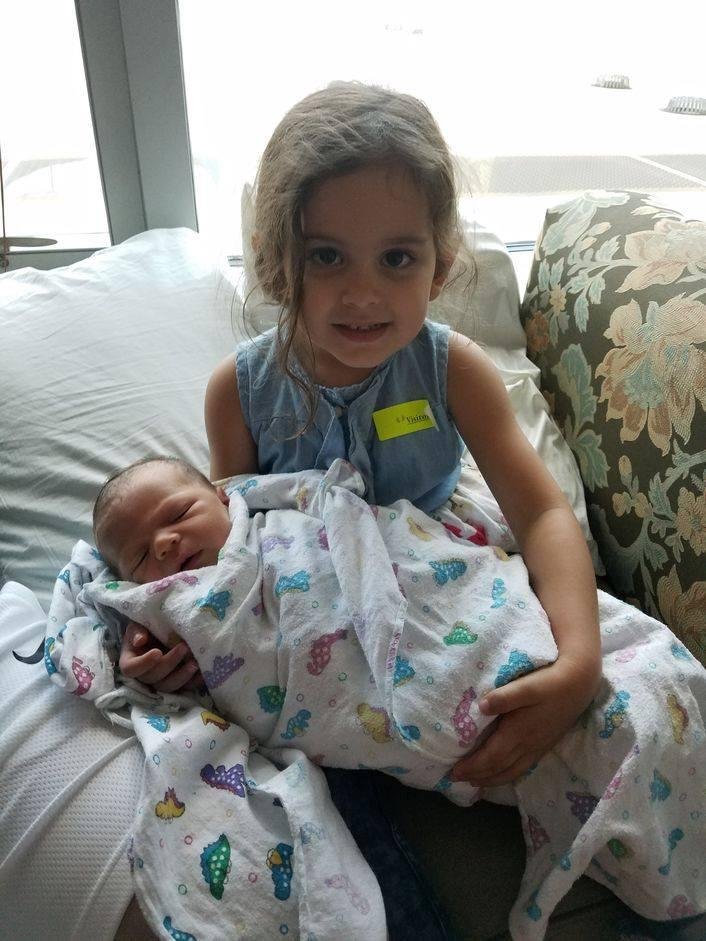 New grandbaby (Scott and Amina). They named him Vander Waylen Garrison. Violet his sister likes to hold him. We are very proud.