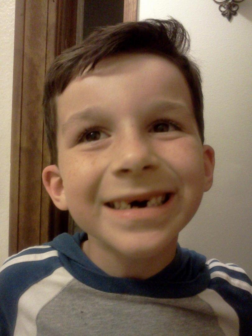 It's Easter Sunday, and I thought I'd add a picture of Mi Nieto, Levi. I tricked him into letting me pull the a tooth that was hanging on like chad on a Florida ballot. After the initial shock, he was proud of his open grin