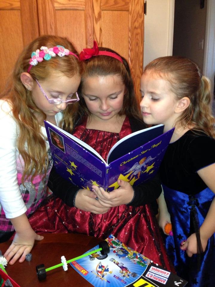 Granddaughters reading and enjoying a book written and illustrated by my cousin Marilyn Ruzicka.