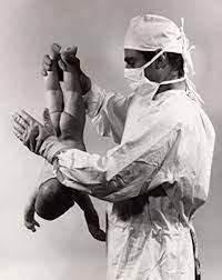 When a child is born, the Delivering Doctor gives it a slight slap on the backside..The Child begins to cry drawing its first breath of life..It also drains the remaining fluid that might be present in the child's mouth fro
