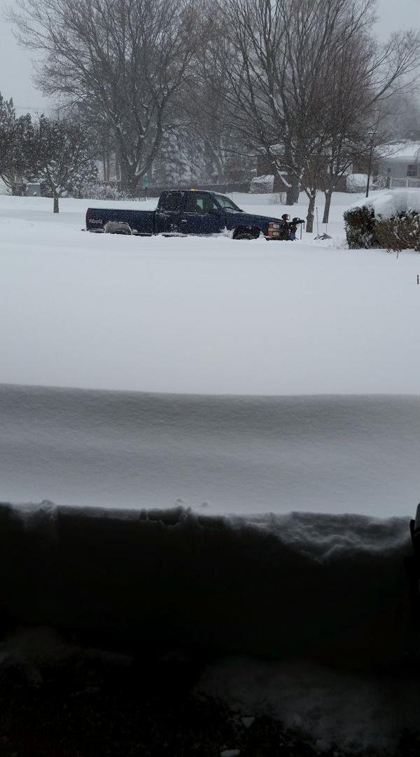 The plow truck is here! Photo from inside our garage. 27 inches and still snowing.