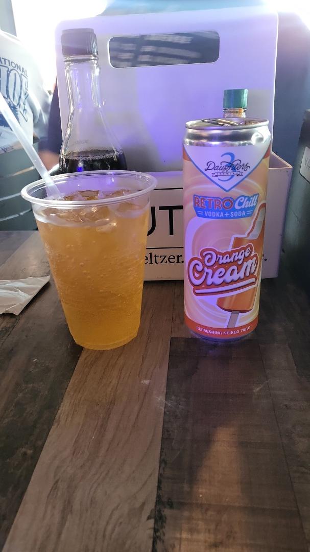Burger and beer at the local pub, Sandy Collins-Engebretsen likes the orange and cream seltzer.