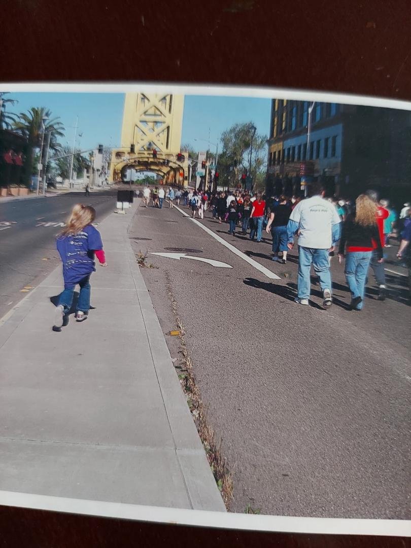 Clyde Moore , March of Dimes Walk. I'm not sure what year this is but that little blond in the purple March of Dimes t-shirt is Ann. To the right is you and Chris. Ann started walking in March of Dimes with me when she wa