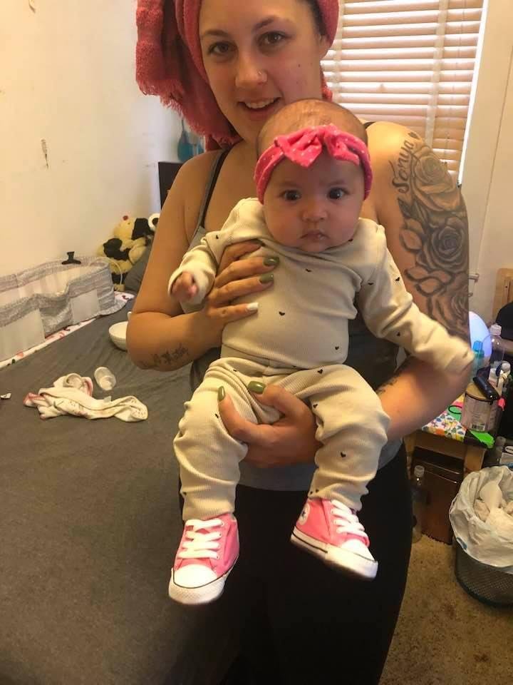 My granddaughter Amiah with pink Chucks, her first kicks.