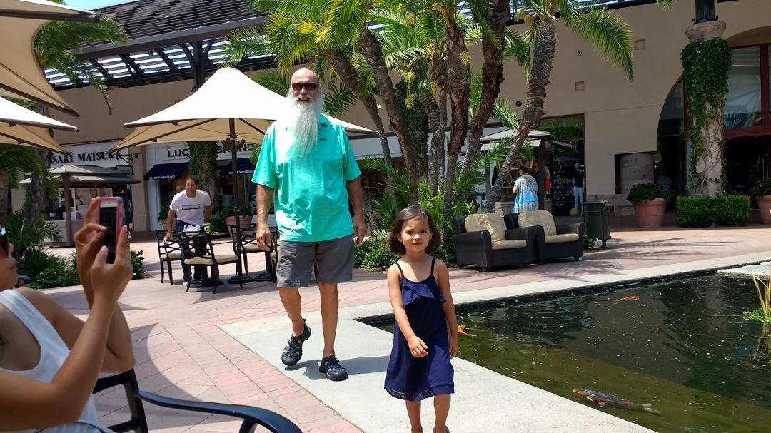 Paris leading Papa Mark around the Koi and at Fashion Island.