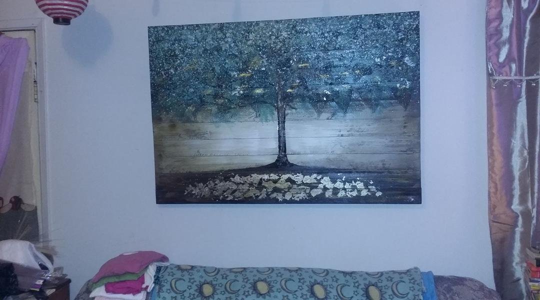 Eric got me this awesome painting for Christmas...the way it's painted fascinates me, there are the web-like, skeletal frames of leaves (real ones!) embedded in the paint... and the colors are amazing...I think it looks gr