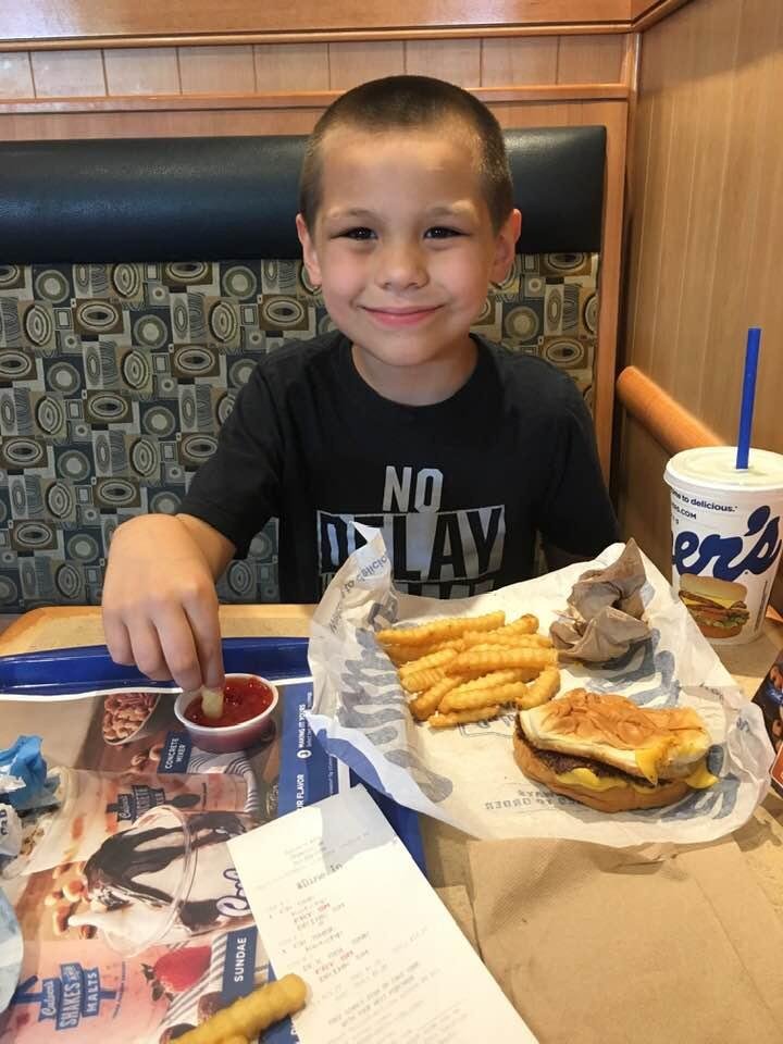 Grandson Drake and NaNa enjoying lunch at Culver’s this afternoon .
It’s his second cheeseburger , boy can eat